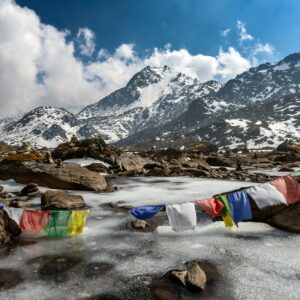 Prayer flags above a frozen lake in Langtang National Park, Nepal