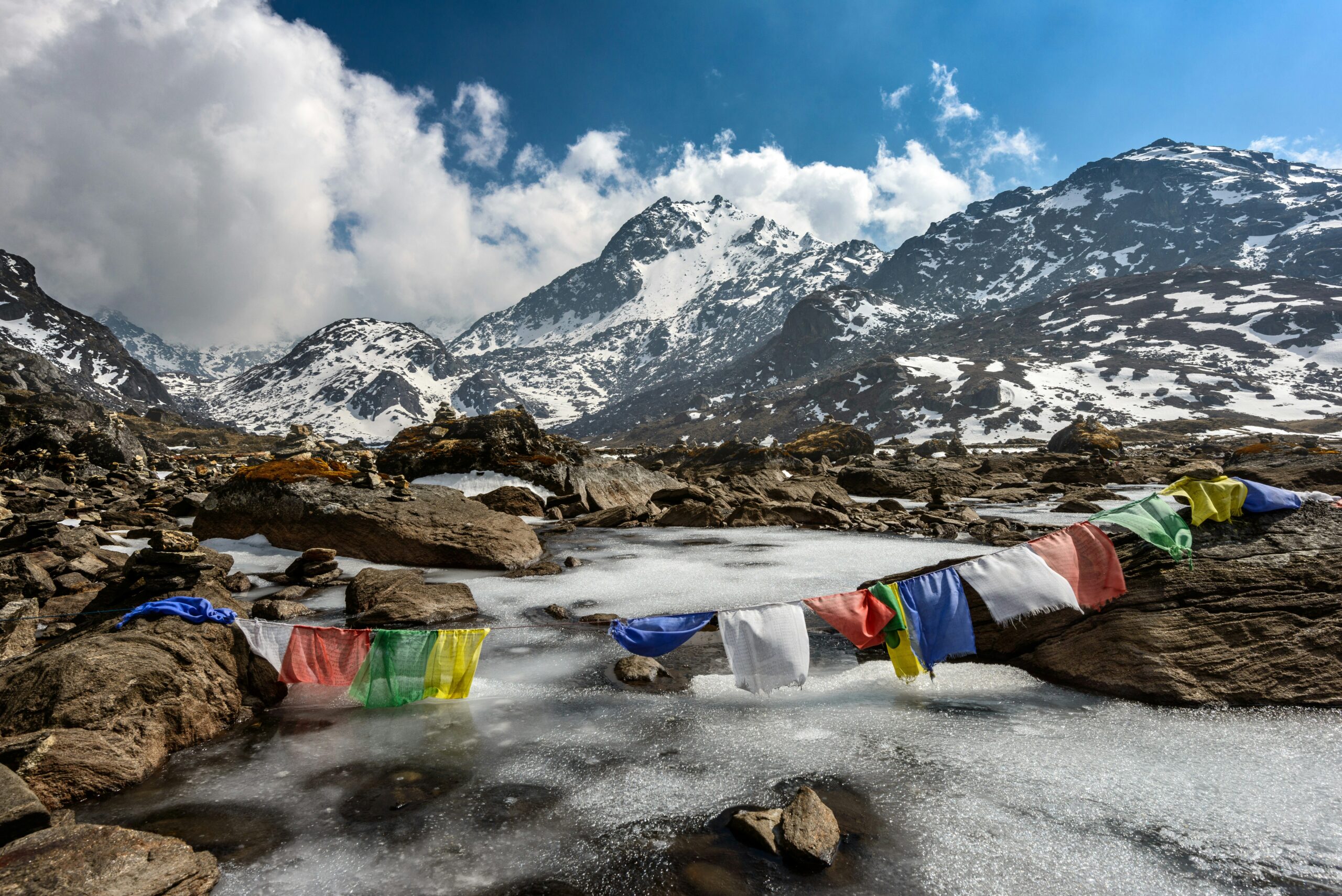 Prayer flags above a frozen lake in Langtang National Park, Nepal