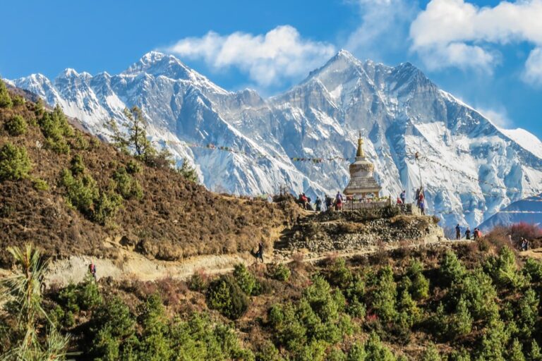 Buddhist stupa below Himalayan peaks in Nepal