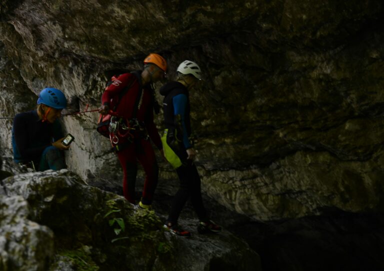Canyoning: abseiling and jumping down a waterfall in a gorge